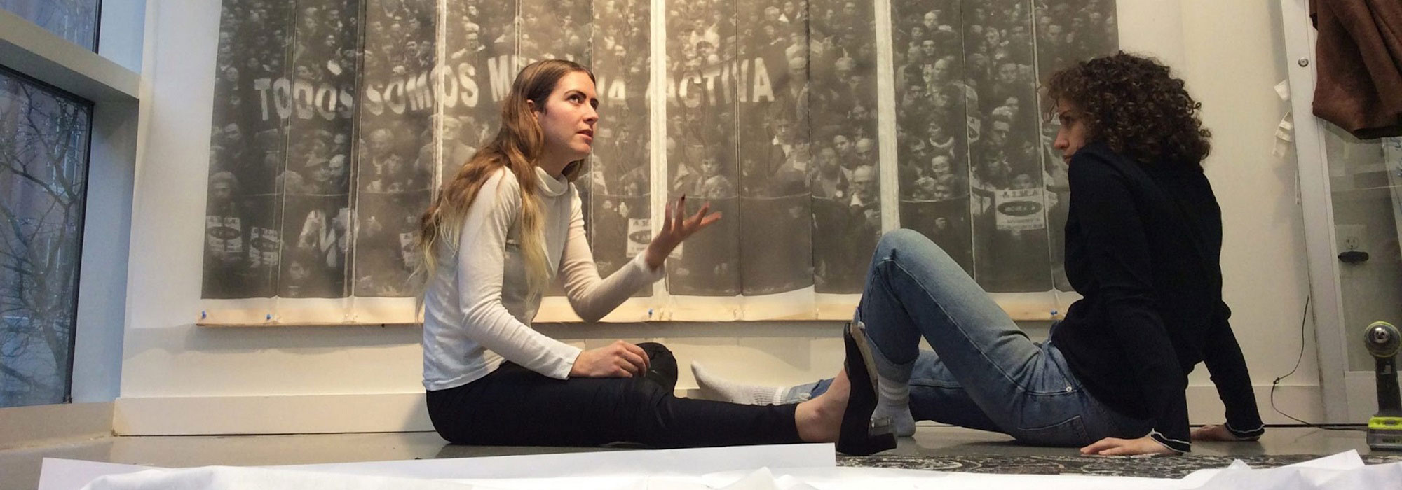 people sitting in front of art